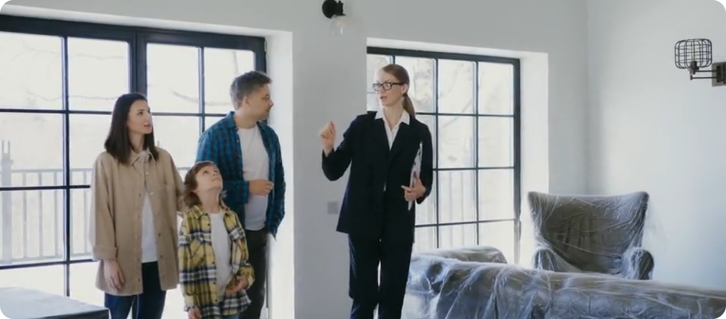A property agent giving a family a house tour