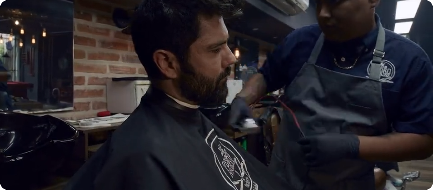 A barber working with a client