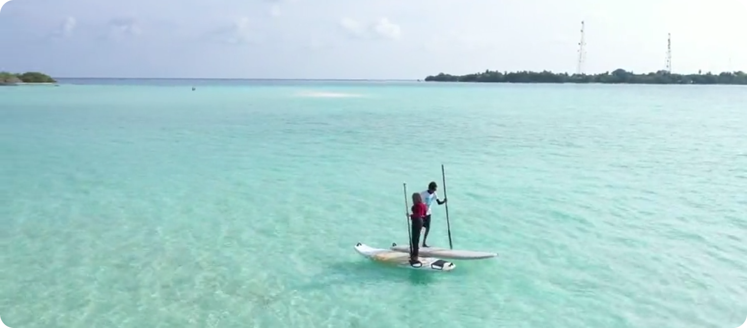 Guests paddleboarding on the sea