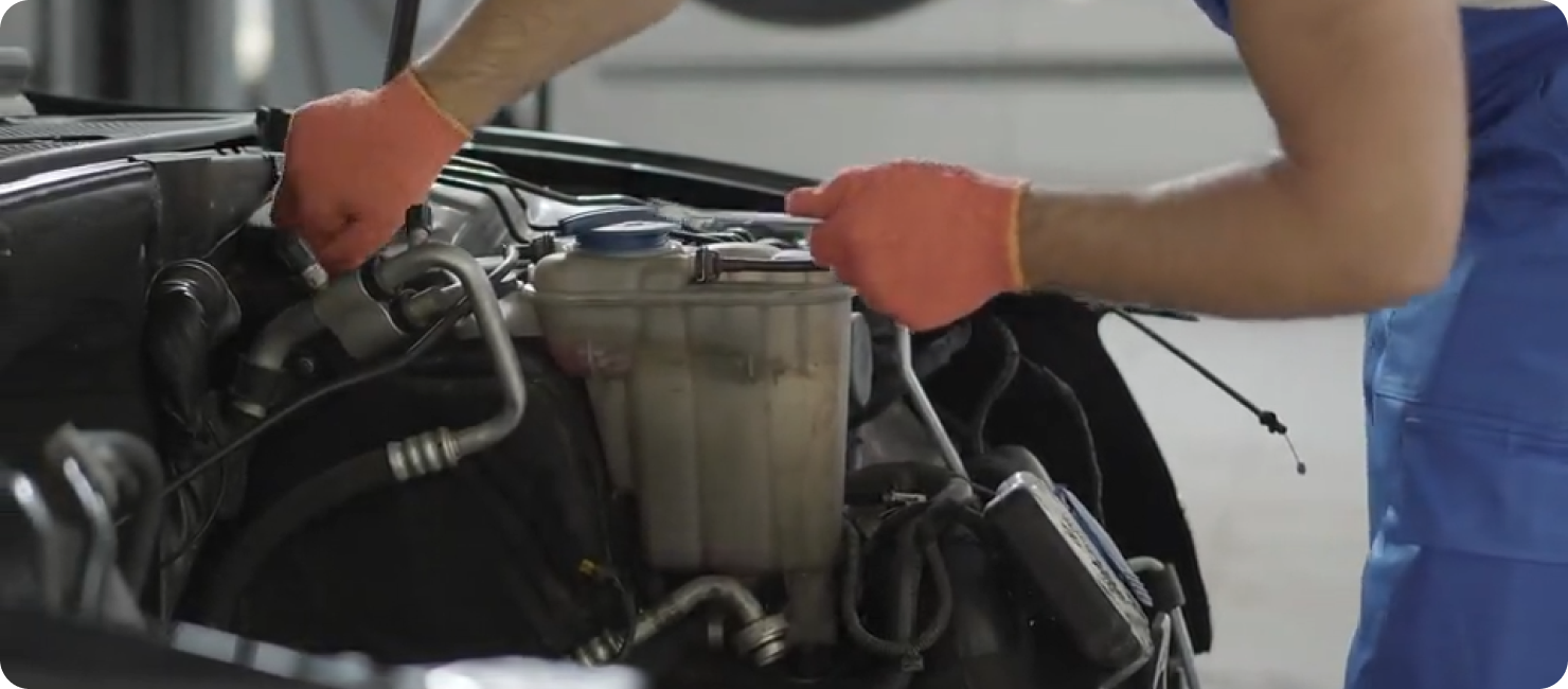 A mechanic working on a car engine