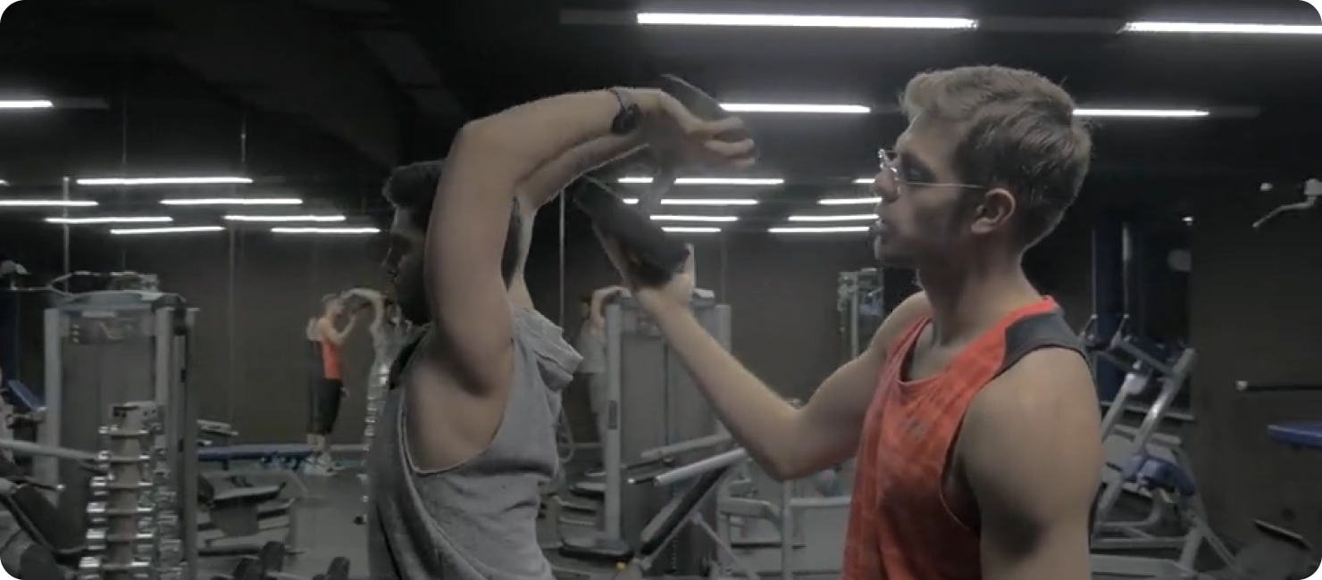 A trainer guiding a client in a gym