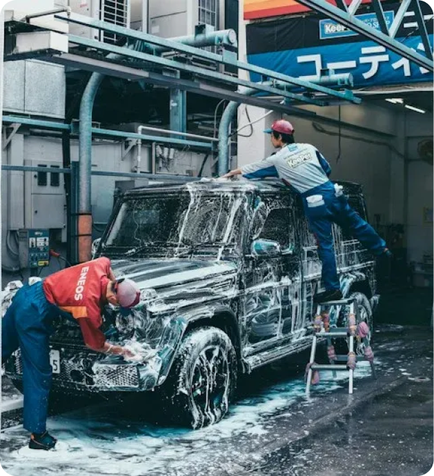 Attendants washing a vehicle